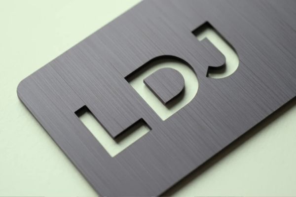 The Letters LDJ cut from metal